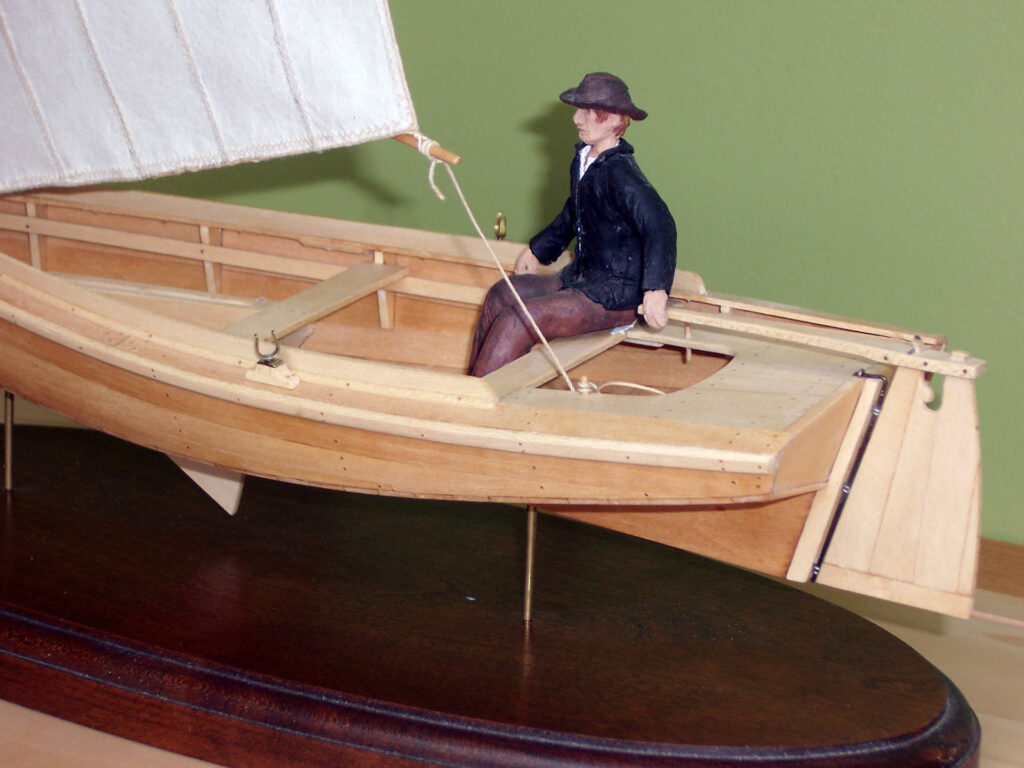 Model of a crabbing skiff - man at the tiller