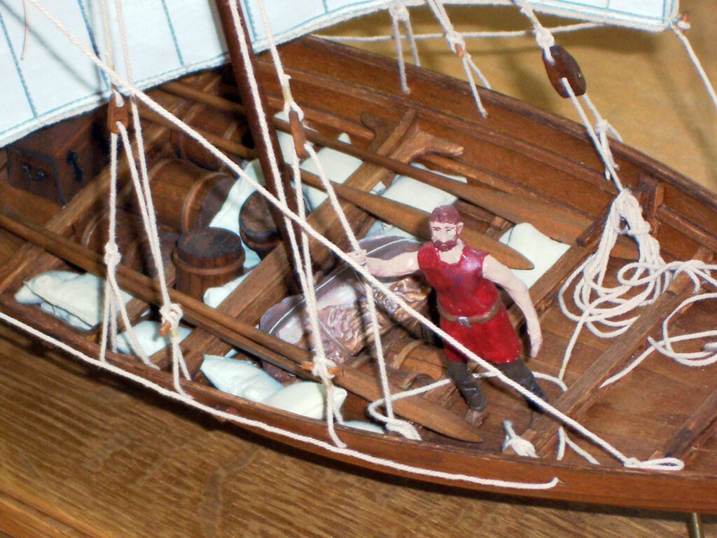 Model of a viking merchant vessel - cargo and man holding shroud